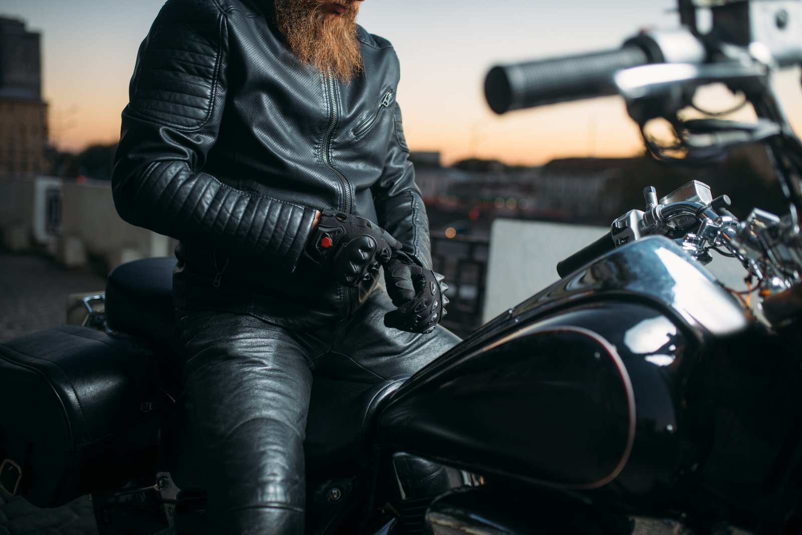biker poses on a motorcycle in city on sunset 2024 11 27 09 53 03 utc scaled
